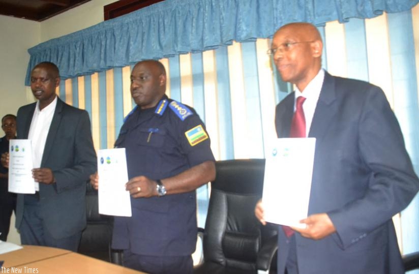 L-R: Augustin Katabarwa, the chairman of NCCR, IGP Emmanuel K. Gasana and Damien Mugabo, the director-general of RCA, display copies of the MoU they signed yesterday. (Courtesy)rn