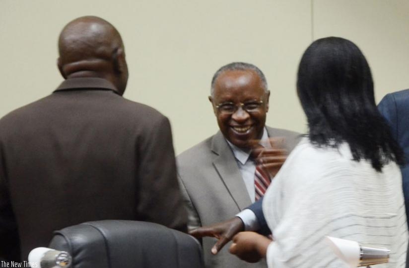 Bishop (Rtd) John Rucyahana (C), the president of NURC, shares a light moment with lawmakers after the meeting yesterday. (Sam Ngendahimana)