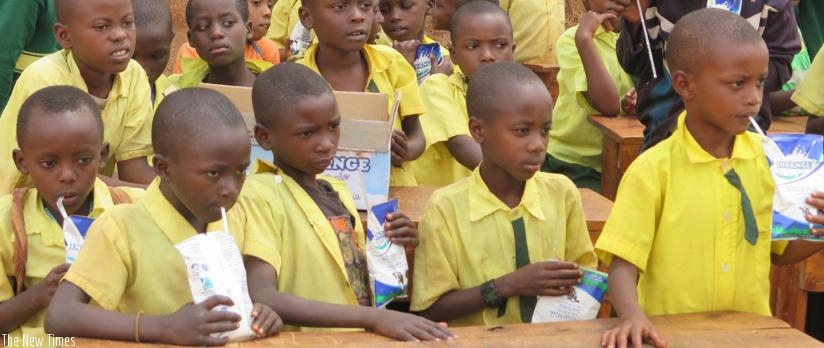 Students from Rango Primary School in Tumba Sector of Huye District drink milk. (Emmanuel Ntirenganya)