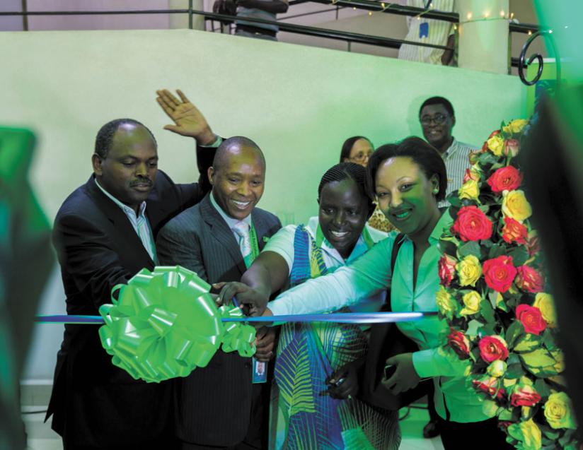 Toroitich (second left) is joined by board members, Dan Zitunga, Specioza Ayinkamiye and Molly Rwigamba, to cut the ribbon at the launch of the new branch at Nyarutarama. (Timothy Kisambira)