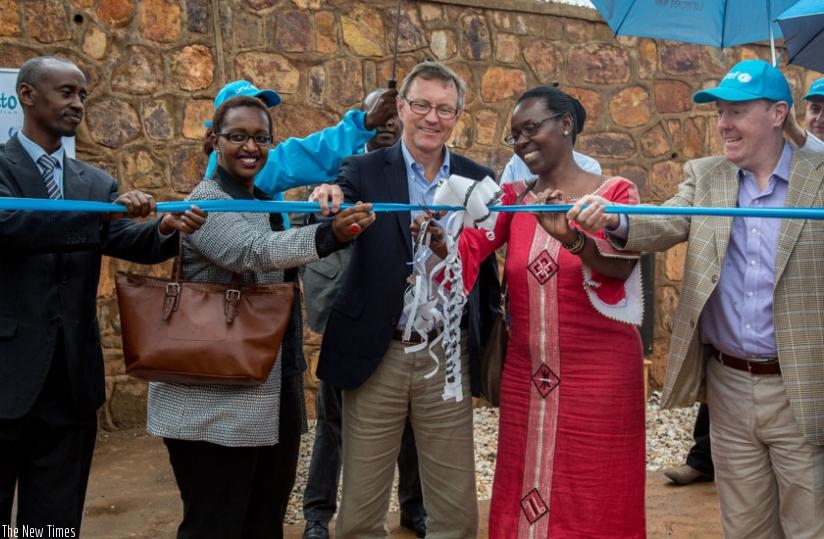 (L-R) Gasabo mayor Stephen Rwamurangwa; Imbuto Foundation's director-general Urujeni Bakuramutsa; Ikea Foundation's CEO Per Heggenes; permanent secretary for MIGEPROF Henriette Umulisa; and Unicef country representative Ted Maly cut a ribbon to officially open the Gikomero Early Childhood Development & Family Centre yesterday. (Doreen Umutesi)