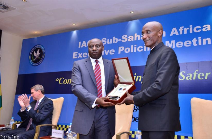 Inspector General of Police Emmanuel K. Gasana presents a souvenir to his Ugandan counterpart, Gen. Kale Kayihura, to whom he handed over the International Association of Chiefs of Police regional chair. (Courtesy)