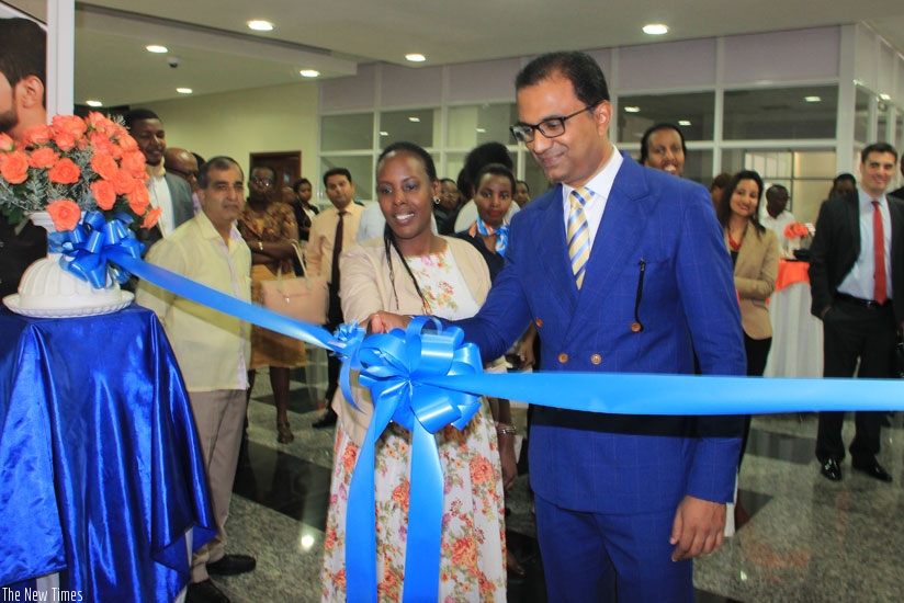 Seerdharan is joined by Linda Mutesi, the Rwanda Development Board head of tourism marketing, to cut the tape at the launch of the flydubai local head office in Kigali last week. (Peterson Tumwebaze)