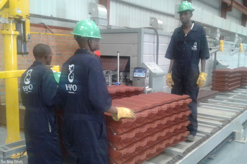 Workers arrange tiles at the Kigali Special Economic Zone based plant. (Peterson Tumwebaze)