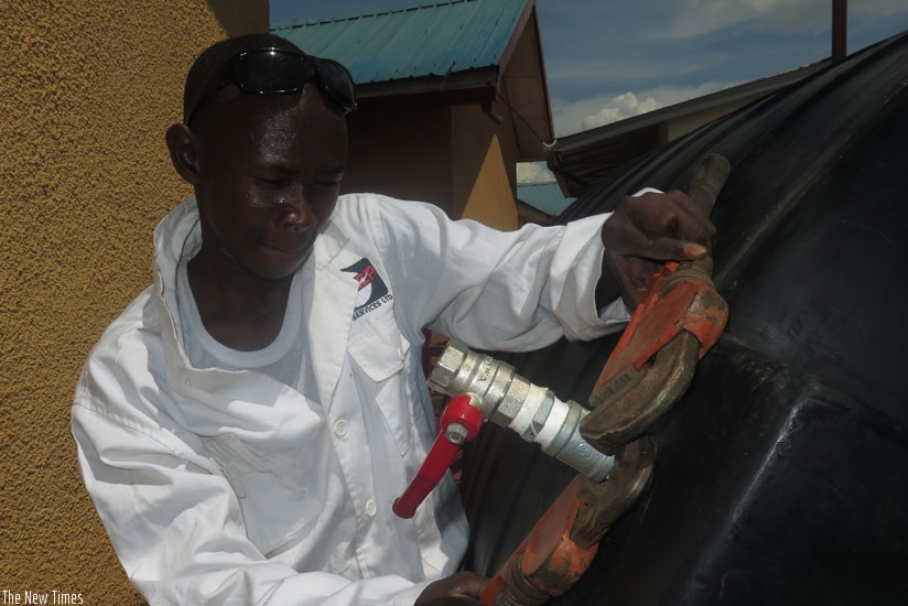 One of the team members at work. The group of 10 technicians provides plumbing, welding and electrical services. (Solomon Asaba)
