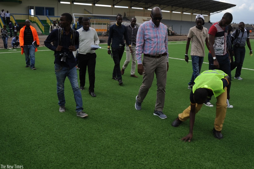 FERWAFA president Vincent Degaule Nzamwita takes journalists on a guided tour of the Stadium in Rubavu yesterday.  (Courtesy)
