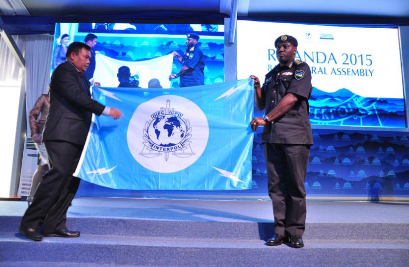 IGP Emmanuel K. Gasana hands over a flag to his Indonesian counterpart as a symbol that the Asian country will host the next Interpol meet. (Courtesy)