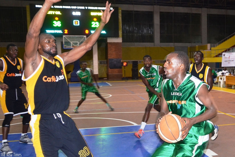 Espoir's Mugabe (R) is defended by City Oilers' and international teammate Kami Kabange during this year's Zone V Club tourney in Kigali. (Sam Ngendahimana)
