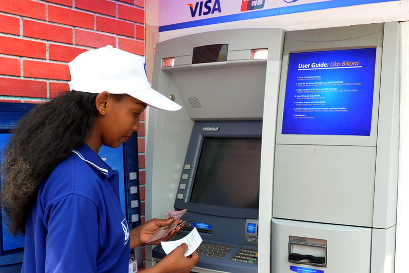 A Bank of Kigali client withdraws money at an ATM that accepts Visa, UnionPay, Diners Club International and RSwitch cards. Most businesses in Kigali now have POS to facilitate a cashless economy. ( File)