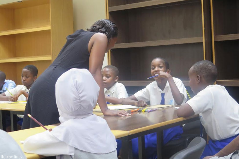 Pupils during a Kinyarwanda book reading session at the National Library in Kacyiru recently. (Solomon Asaba)
