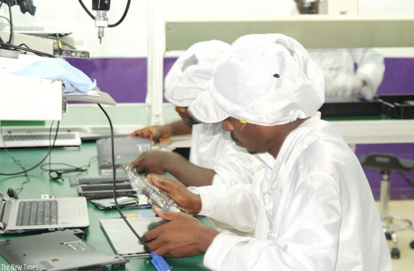 Workers at Positivo BGH make computer devices. (F. Byumvuhore)