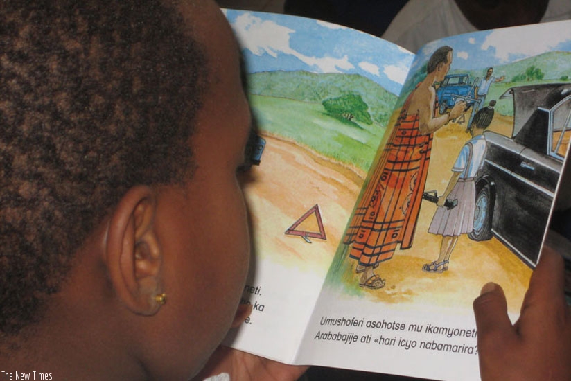 A child reads a story book written in Kinyarwanda. (File)