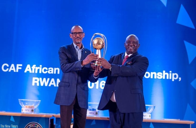 Confederation of African Football (CAF) vice-president and Africa Nations Championship (CHAN) president, Almamy Kabele presents President Kagame with the Rwanda 2016 CHAN trophy in Kigali yesterday. (Village Urugwiro)