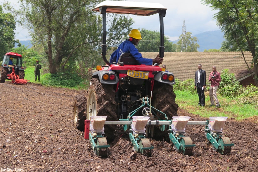 A trainee in agriculture mechanisation plants maize seeds using a tractor at the IPRC South demo farm in Huye District on Friday. (Emmanuel Ntirenganya)