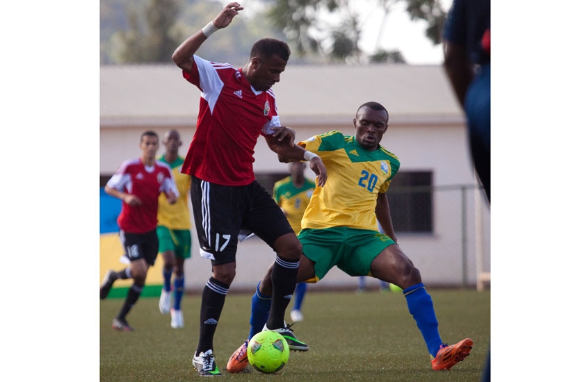 Amavubi forward, Jacques Tuyisenge tackles Libya's defender  Abdelrahman Fetori, the last time the two teams met in Kigali. (File)