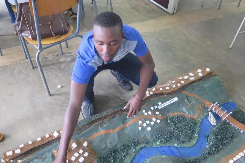 A student displays the settlement plan around Nyamirambo stream. (All photos by Solomon Asaba)