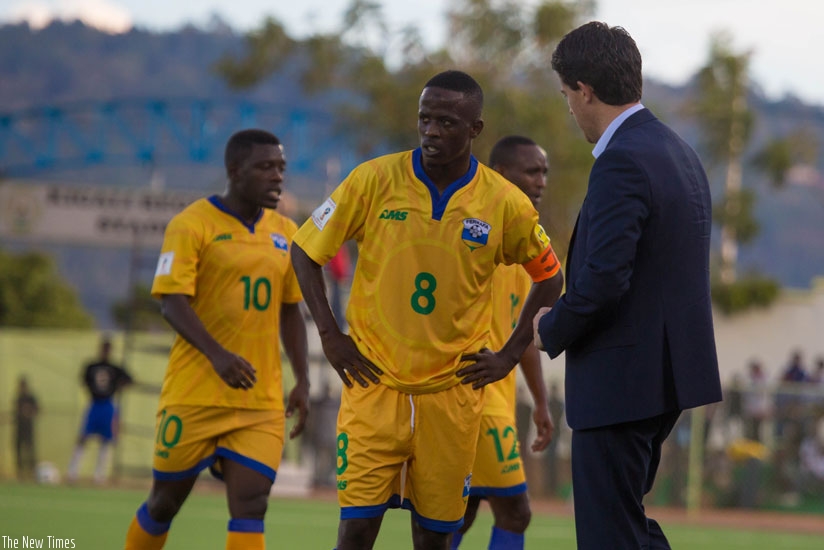 Amavubi head coach Johnny McKinstry ,speaks to Haruna Niyonzima  the team captain in the second half of the game.(All photos by Timothy .Kisambira)