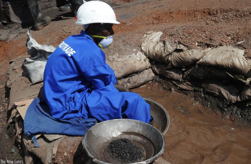 A miner sorts minerals using water. (File)
