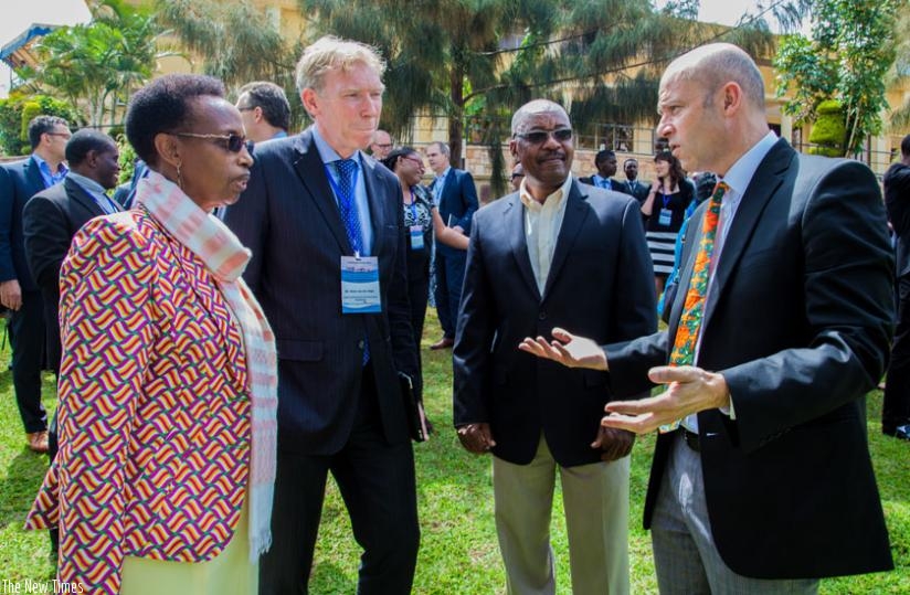 L-R; Dr Gasingirwa, Victor Van Der Chijs, the president of Executive Board of University of Twente; Prof. Manasse Mbonye, the Principal College of Science and Technolgy at the Univeristy of Rwanda, and Prof. Cotton chat on the sidelines of the conference. (Faustin Niyigena)