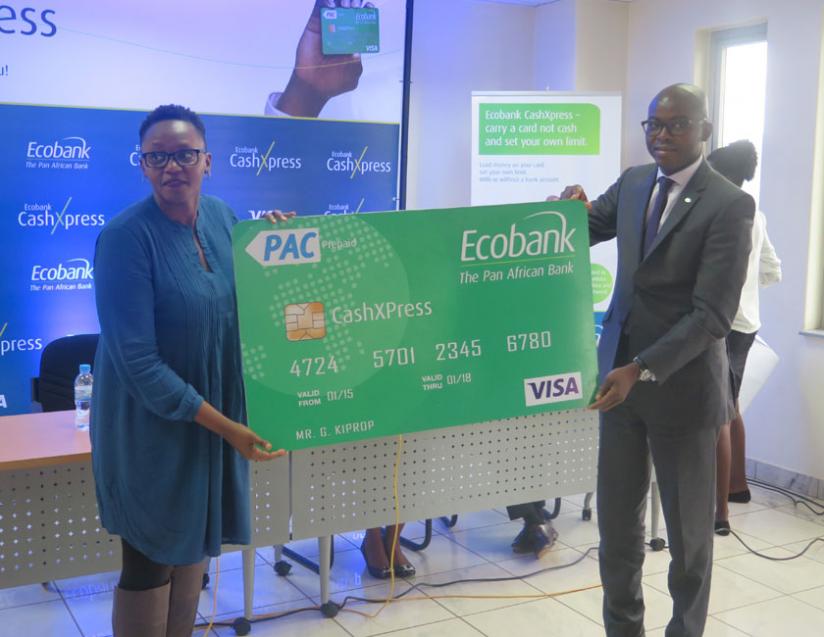 Lucy Mbabazi(L) VISA representative and Wilfrid Bocco, Head of domestic Banking at Ecobank display the prepaid cashXpress card.