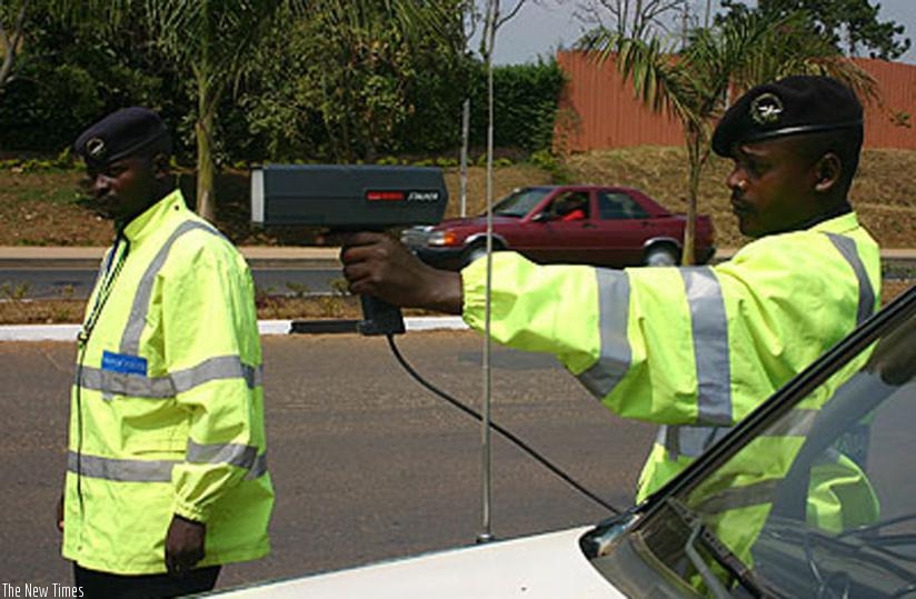 A traffic policeman using a speed gun to check the speed of an approaching vehicle. (File)