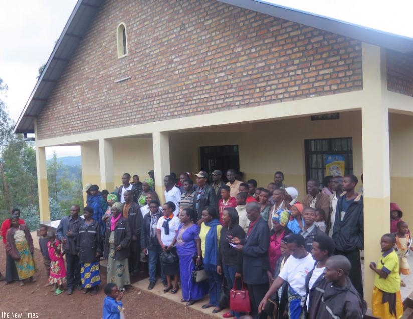 Nyankenke residents and sponsors pose for a group photo at the new health facility. (Frederioc Byumvuhore)