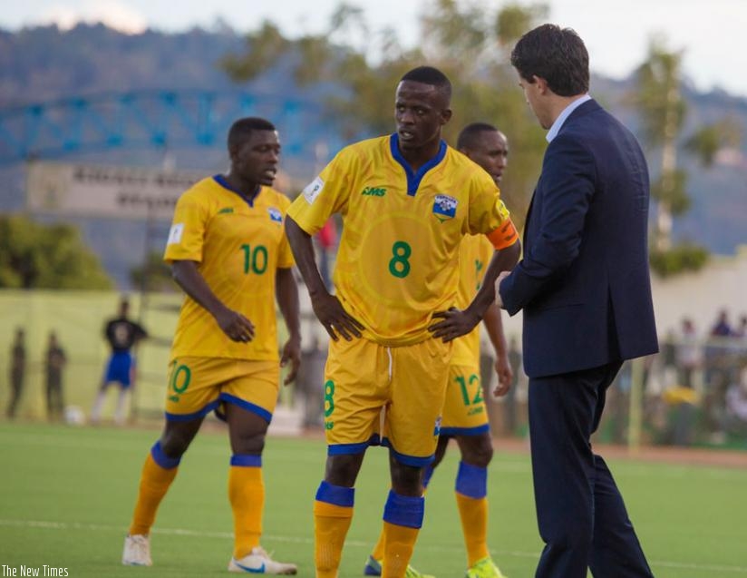 McKinstry speaks to Amavubi captain Haruna Niyonzima in the second half of the game against Libya on Tuesday. (T. Kisambira)