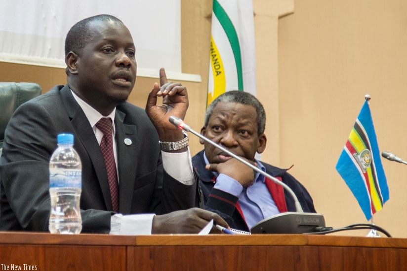 The Speaker of the East African Legislative Assemly, Daniel Kidega, addresses journalists at Senate Hall in Kigali as MP Charles M. Nyerere, a Tanzanian Assembly member, looks on yesterday. rn(All photos by Doreen Umutesi)