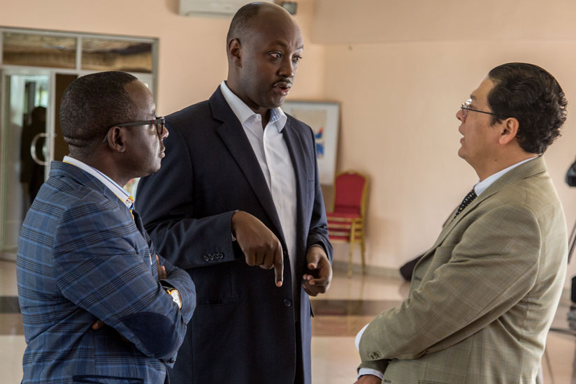 (L-R) Damien Mbatezimana, Founder of Shekina food processing and Exportation Company, Robert T. Runazi, General Manager Kinazi Cassava Plant, and Sebastian Rodas, Regional Trade Promotion Adviser,  International Trade Centre exchange ideas during the market access dialogue in Kigali, yesterday. (All photos by D. Umutesi)