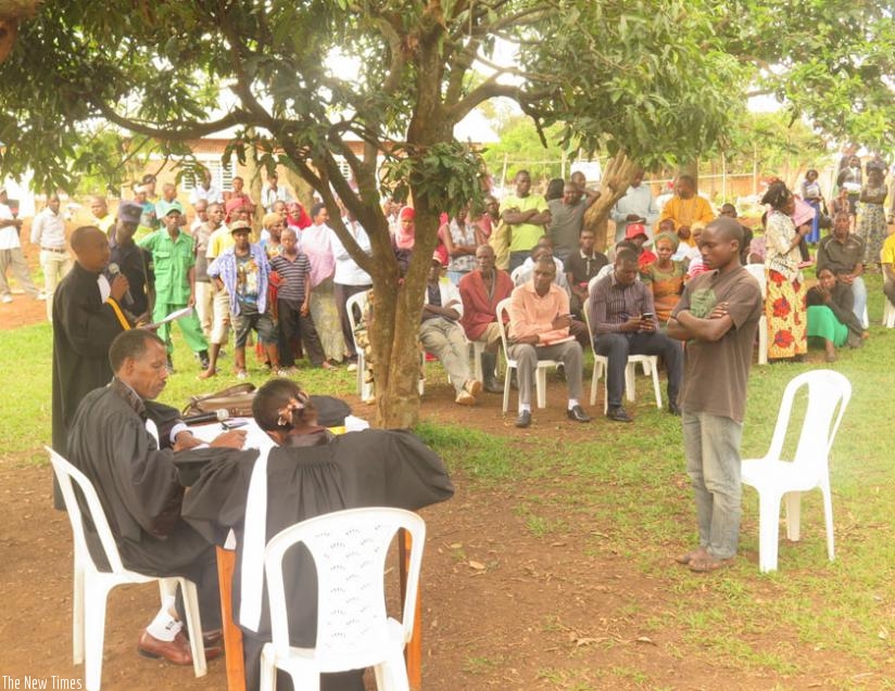 Habakurema (standing) during the court session in Kigabiro sector. (S. Rwembeho)