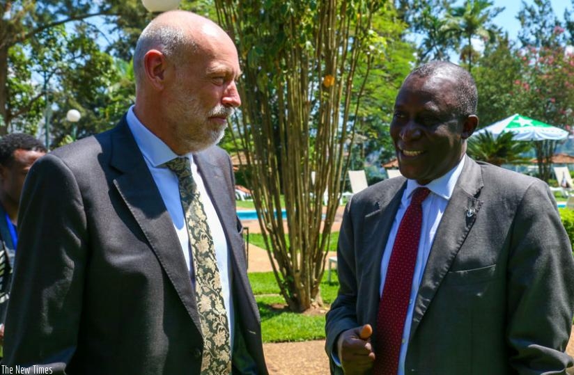 Cauwenbergh (L) chats with Maiga during a break at the workshop in Kigali yesterday. (Timothy Kisambira)