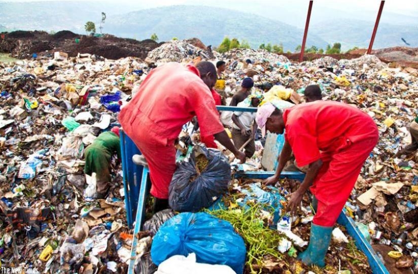 Workers at Nduba dump site in Gasabo District sort out gabbage. (File)