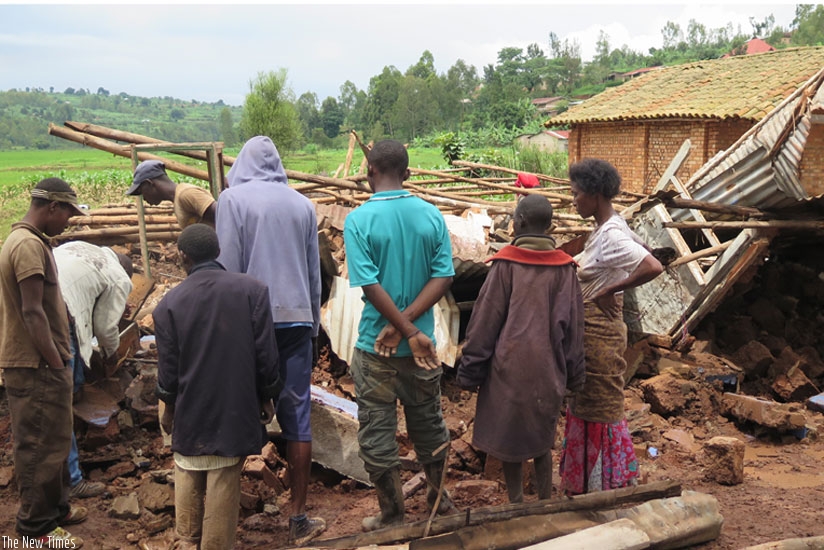 Residents of Mbazi Sector near Rwabuye marshland assess the damage caused by last weeku2019s downpour. (Emmanuel Ntirenganya)