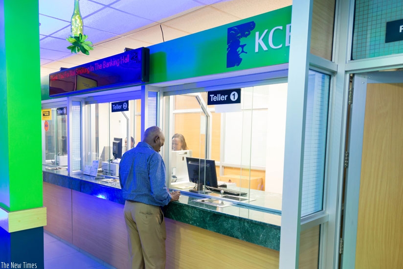 A customer transacting at the newly opened KCB Nyarutarama branch. The banku2019s profit before tax was driven partly by strong customer deposit base. (Courtesy photo)