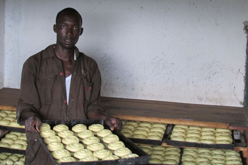 The baker prepares to put buns in the oven. The young entrepreneur is a former street dweller. (All photos by Dennis Agaba)