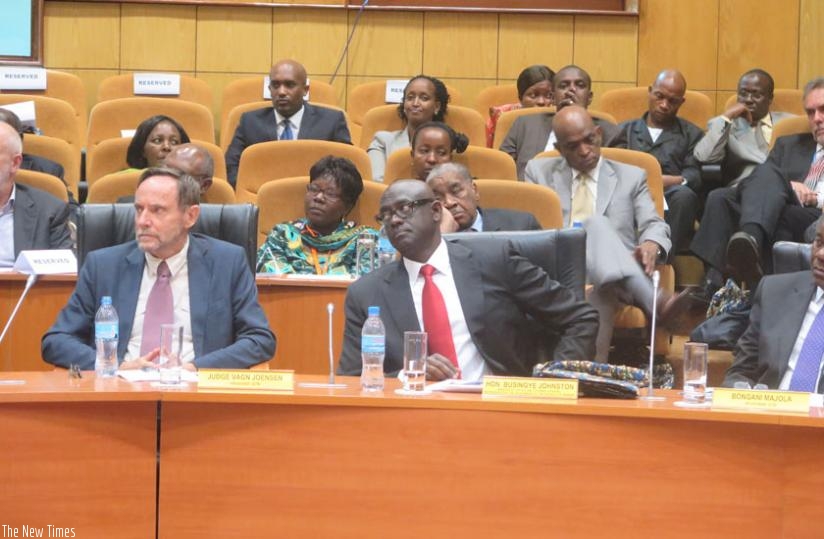 Judge Joensen ( L), Busingye and other officials follow proceedings in Arusha yesterday. (Courtesy(