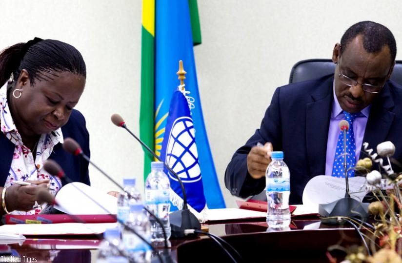 Diarietou Gaye, World Bank regional director for Kenya, Rwanda, Uganda and Eritrea (L), and Finance minister Claver Gatete sign paperwork for a $95 million (about Rwf70 billion) International Development Association (IDA) credit agreement to support social protection programmes in Kigali yesterday. (Timothy Kisambira)