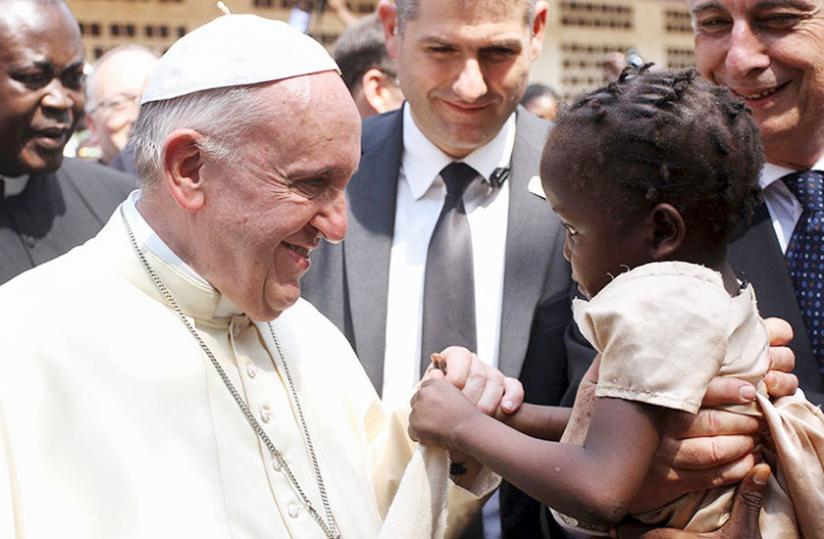 Pope Francis greets a girl on the grounds of the Saint Sauveur church which shelters internally displaced people in Bangui, Central African Republic during tour of Africa. (Net photo)