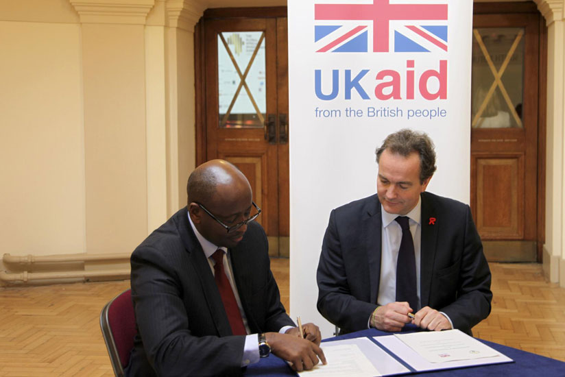Ministers Musoni and Hurd sign the solar energy deal in London yesterday. (Courtesy)