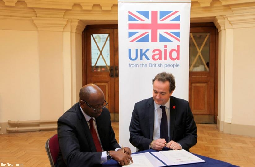 Minister Musoni and Hurd sign the power deal in London on Wednesday. (Courtesy)