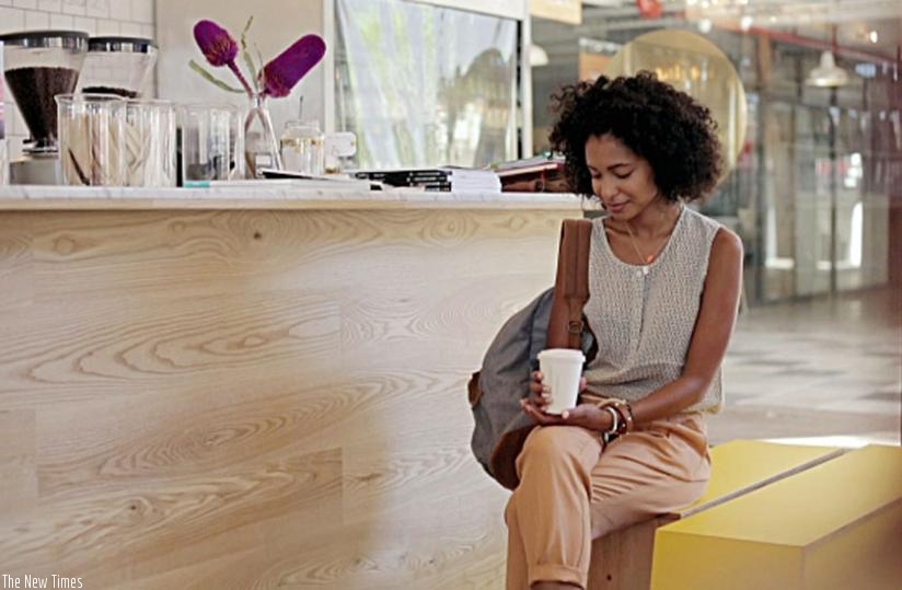 A woman relaxes as she drinks coffee.  (Net photo)
