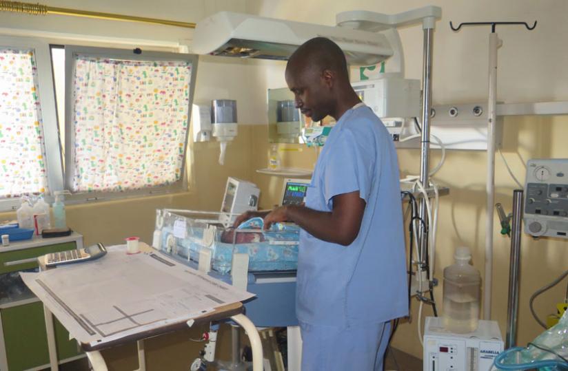 A nurse adjusts the position of a neonate in a hospital. The infants section is one of the high risk areas hence high standard safety precautions are needed there. (Solomon Asaba)