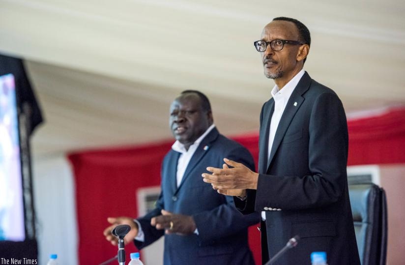 President Kagame and RPF vice-chairman Christophe Bazivamo applaud at the Political Bureau caucus yesterday. (Village Urugwiro)rn