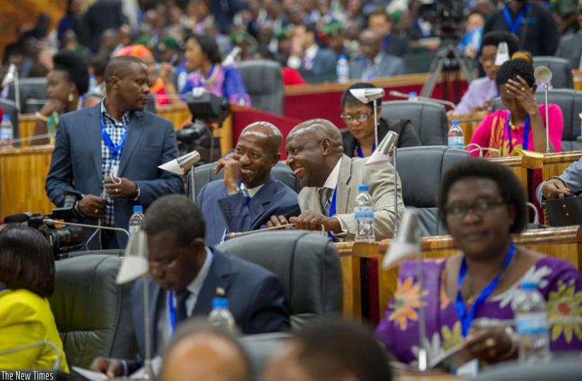 Internal Security minister Sheikh Musa Fazil Harerimana and MP Abbas Mukama share a light moment at last yearu2019s Umushikirano. (Timothy Kisambira)