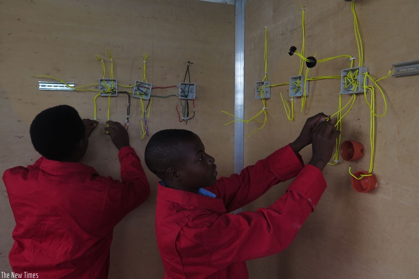 Electrical installation students carry out a wiring experiment. 