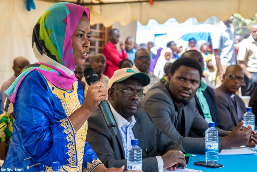 Member of Parliament Nura Nikuze (L) speaks to the residents of Gikomero in Gasabo District about the proposed amendment of article 101 of the Constitution on July 20. (File)