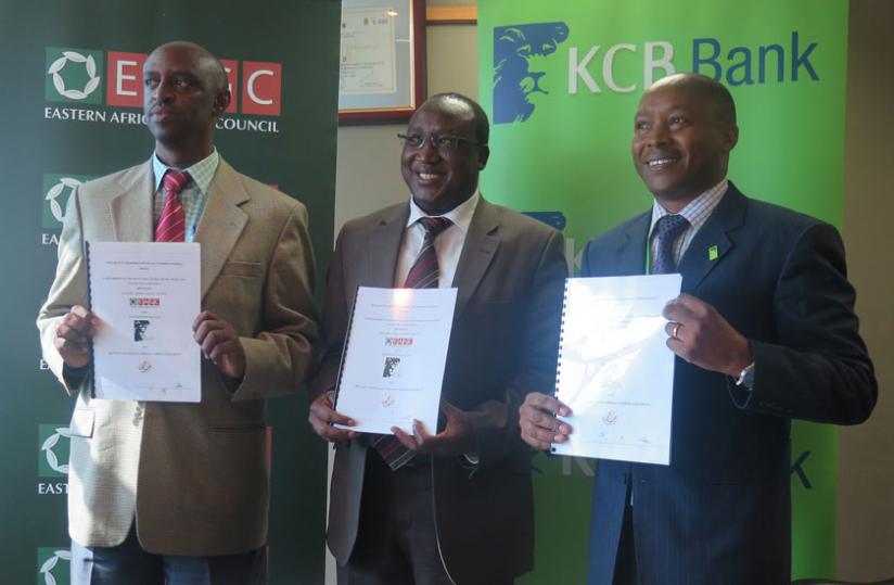Rwibasira, Masila and Toroitich display signed documents. The partnership seeks to boost agro-funding and grain production. (Shamim Nirere)
