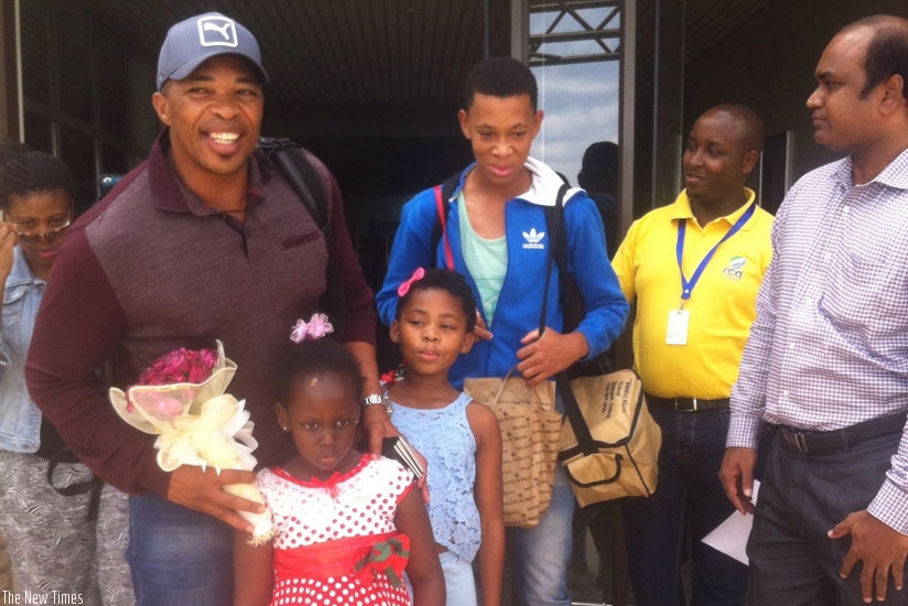 Makhaya Ntini (L) with his family on arrival at Kigali International Airport. RCA boss Charles Haba (2nd right) and his deputy Srinath Vardhineni (R) received him at the airport yesterday. (Courtesy)