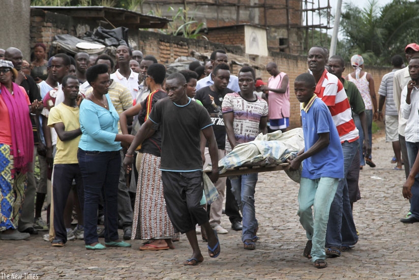 Men carry away a body in the Nyakabiga neighbourhood of Bujumbura, Burundi on Saturday. (internet photo)