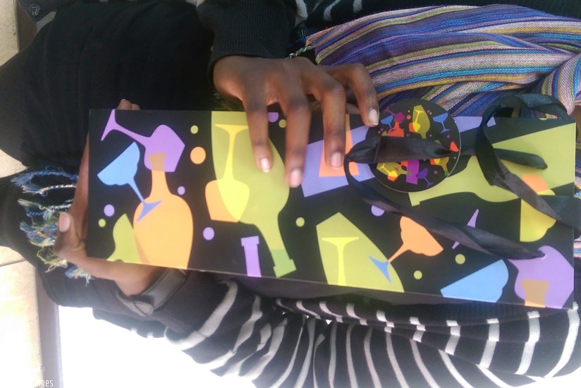 A shopper displays a gift.This year, prices have been relatively low compared to 2014. (Dennis Agaba)